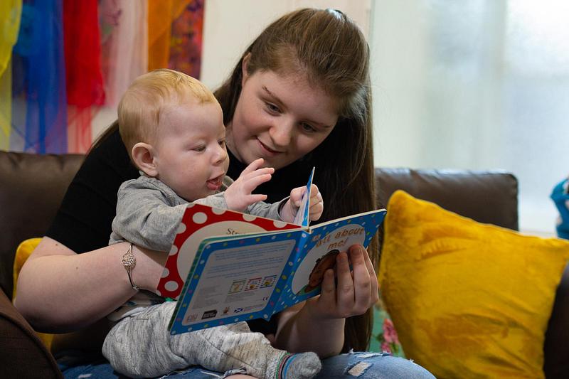 A mum and toddler reading together